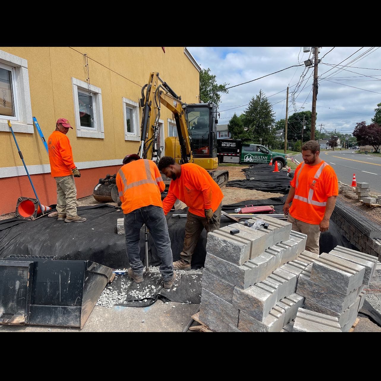 Sultan Services crew building a retaining wall on a commercial site