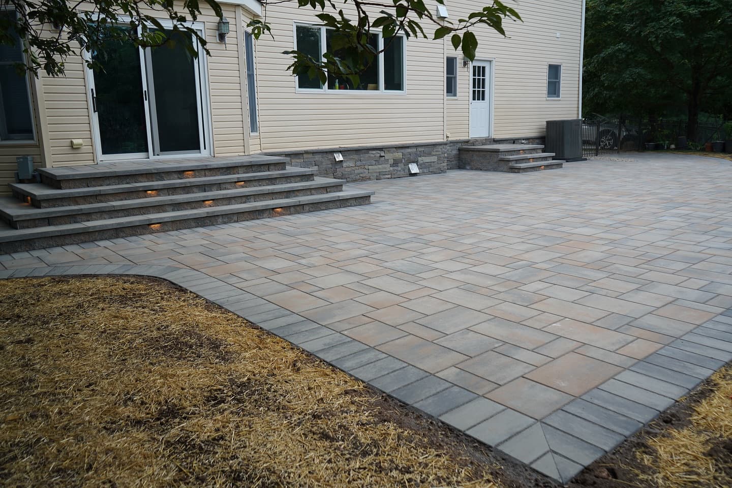 Finished backyard patio with stone veneer steps