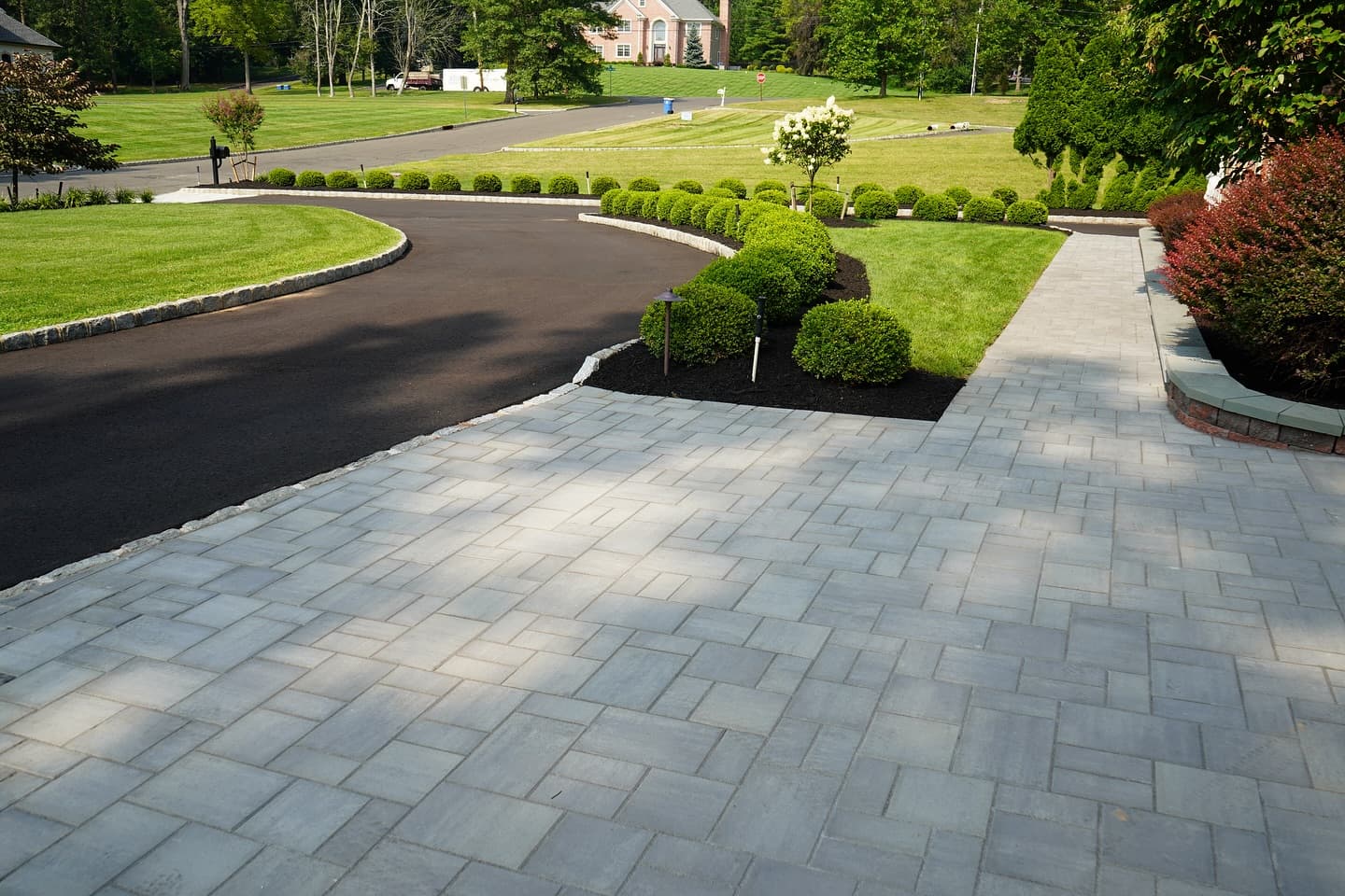Paver entry and driveway apron with a clean hedge line
