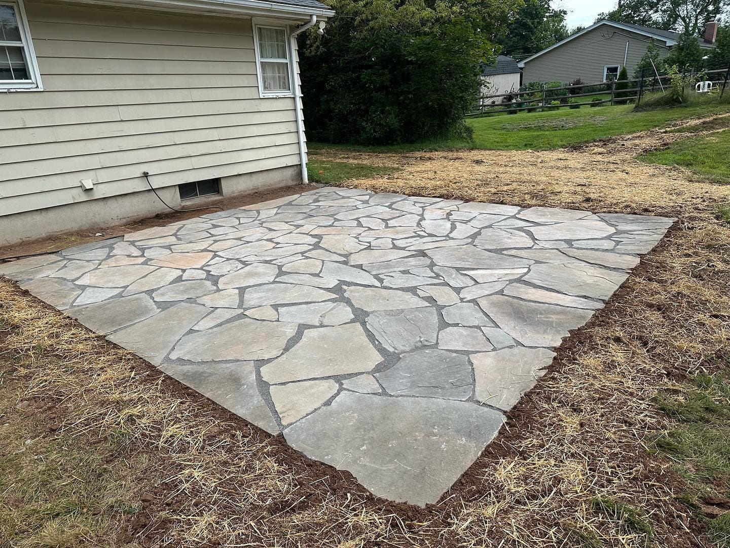 Flagstone natural stone patio installation