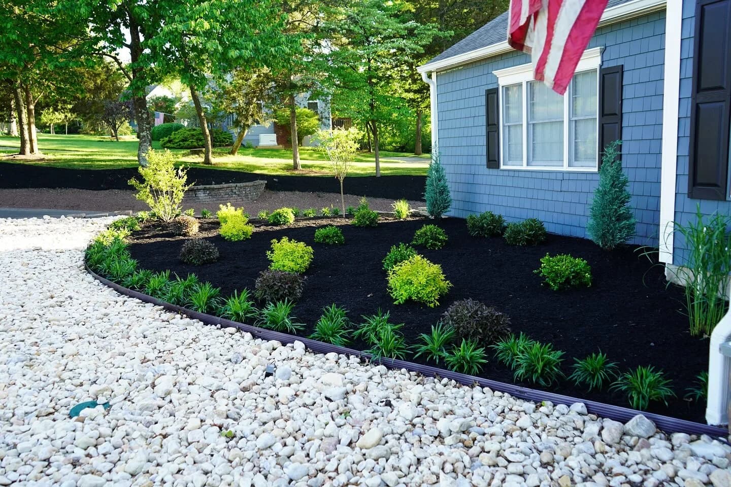 Fresh mulch and clean bed edges along a front walkway