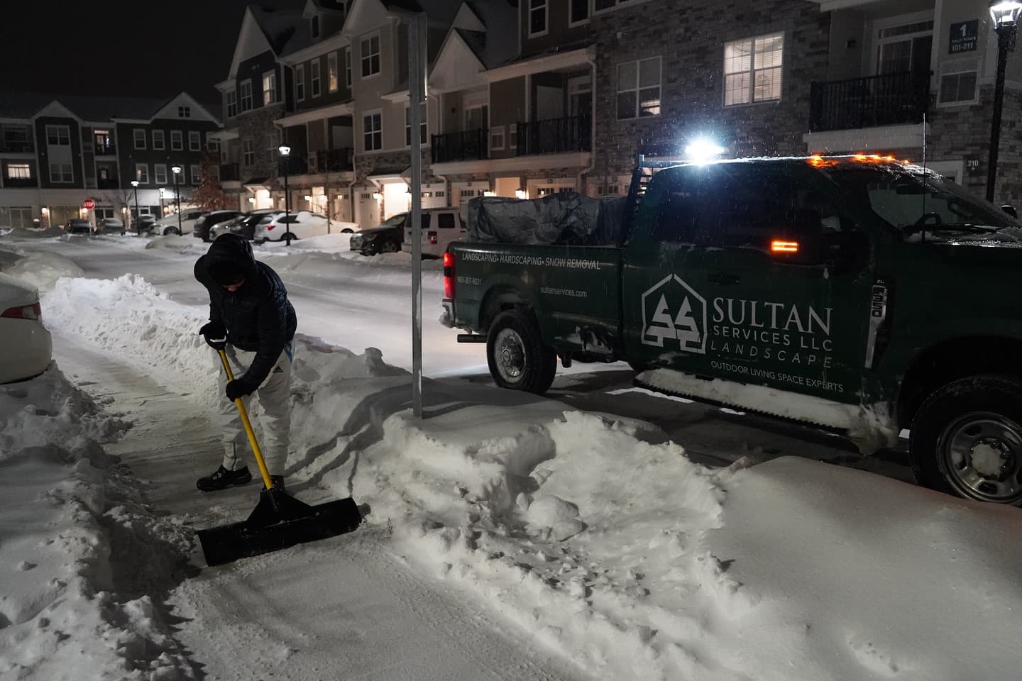 Sultan Services crew member shoveling walkway at townhome community